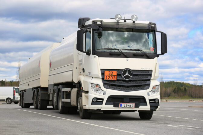 FORSSA, FINLAND - MAY 16, 2015: White Mercedes-Benz Actros 2545 tank truck parked on a yard. The ADR code 33-1203 signifies petrol fuel.